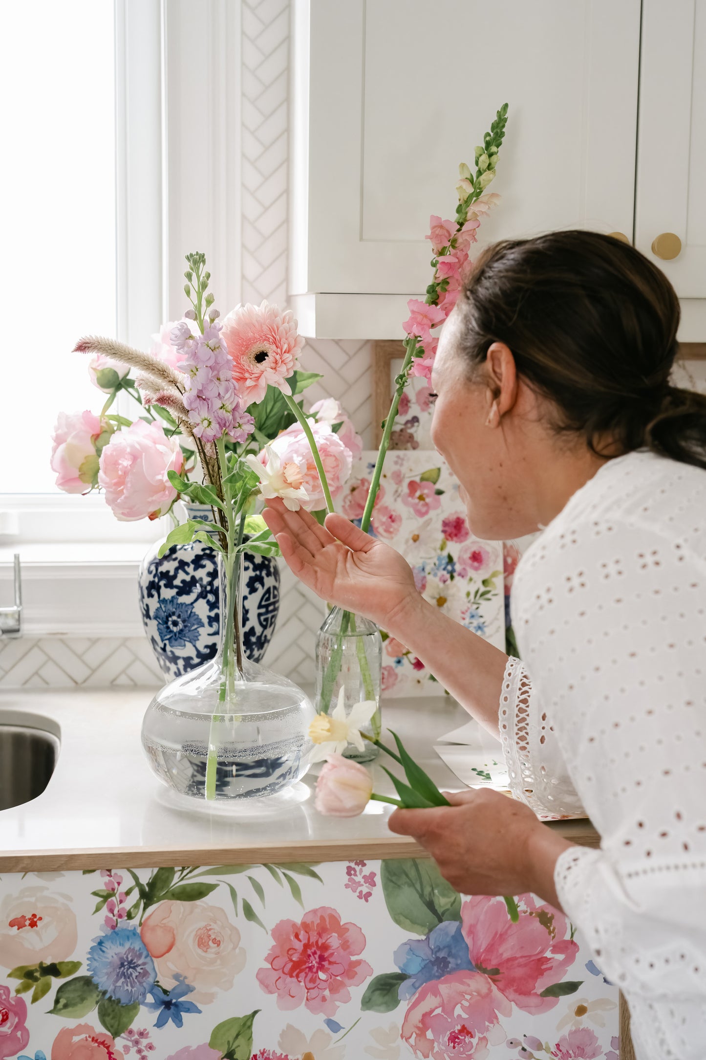 Artist Tonya Cruz admiring inspiration flowers