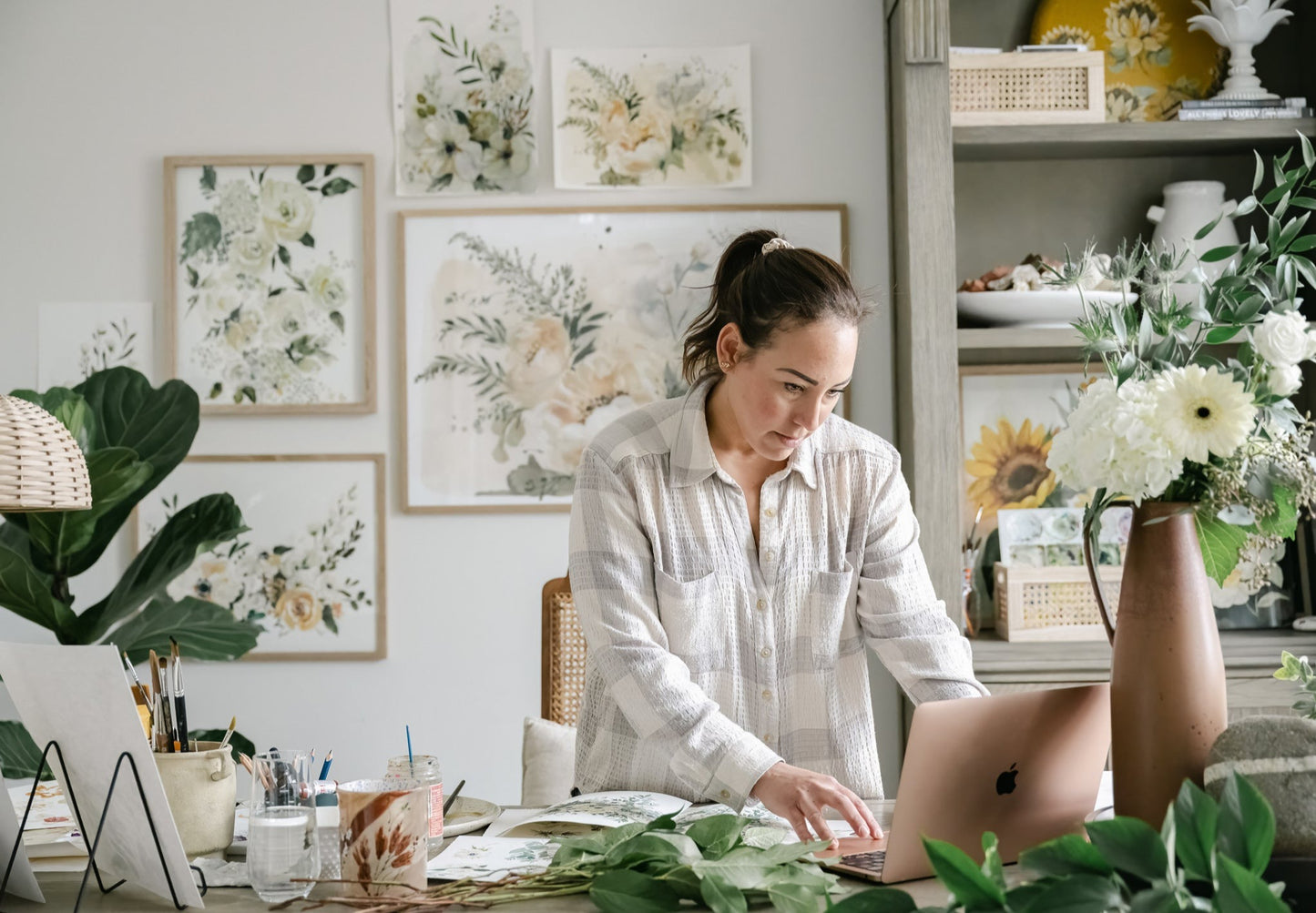 Artist Tonya Cruz  in studio with Lovers Art Print displayed in 24x36" frame