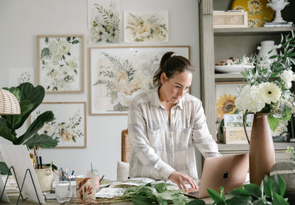 Artist Tonya Cruz  in studio with Lovers Art Print displayed in 24x36" frame